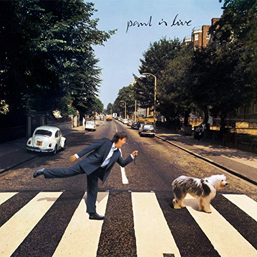 "Album cover: man in suit and dog crossing street, 'paul is live' written above."