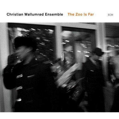 "Album cover with black and white image of people walking past a shop window."
