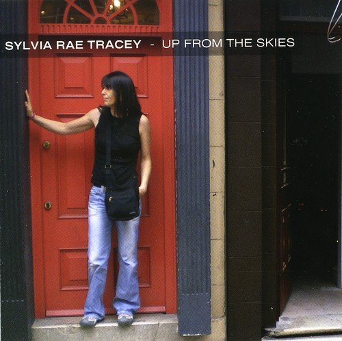 "Album cover featuring a woman standing by a red door, wearing jeans and a black top."