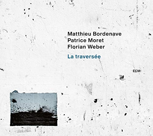 "Album cover with white background, black speckles, and a small abstract image."