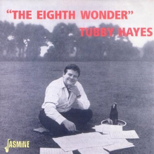 "Album cover with man sitting on grass with papers, bottle, and ashtray."