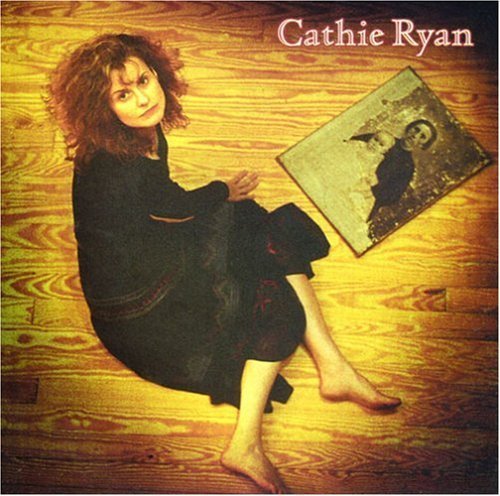 Cathie Ryan album cover featuring a woman sitting on a wooden floor with an old photograph.