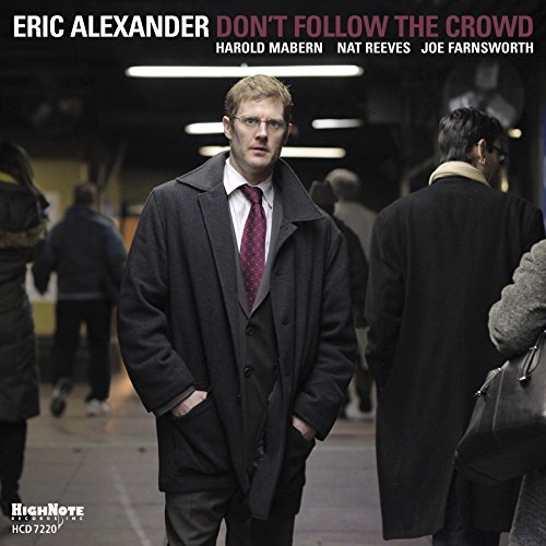 Album cover featuring a man in a coat standing in a crowded subway.
