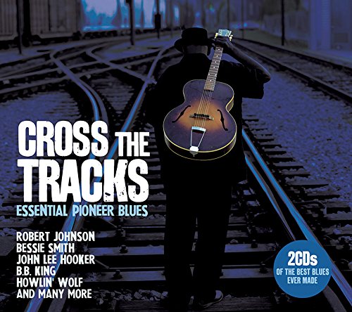 "CD cover featuring a man with a guitar on train tracks, dark background."