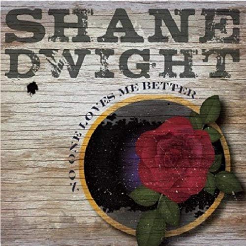 "Album cover with 'Shane Dwight' in bold letters and a red rose on wood."