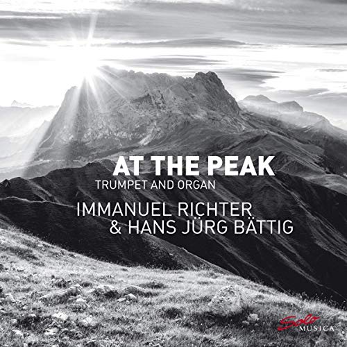 "Album cover with mountain landscape, sun rays, and white text on black-and-white background."