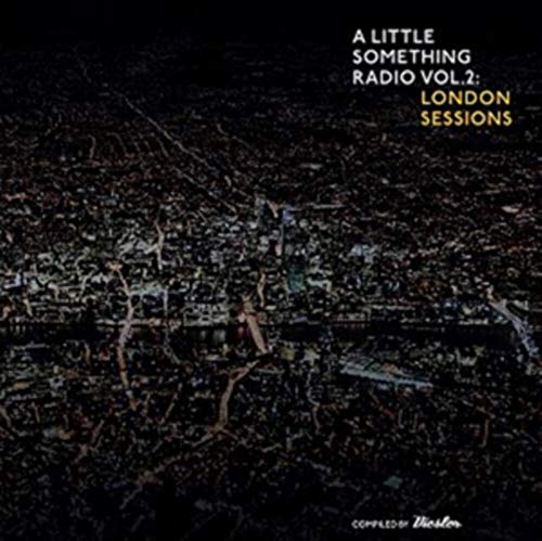 "Vinyl record cover with aerial view of city at night and white and yellow text."