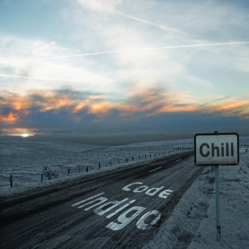 A snowy road with "Code Indigo" painted on it, beside a "Chill" sign.