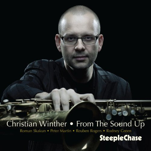 "Album cover with a man holding a saxophone, against a black background."