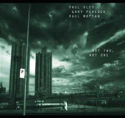 Black and white album cover with cityscape, cloudy sky, and text listing artists and title.