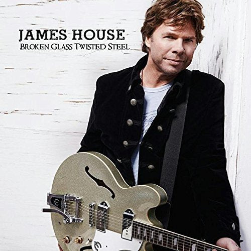 Album cover featuring James House holding a silver guitar against a white wooden background.