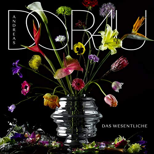 "Album cover with a glass vase of colorful flowers against a black background."