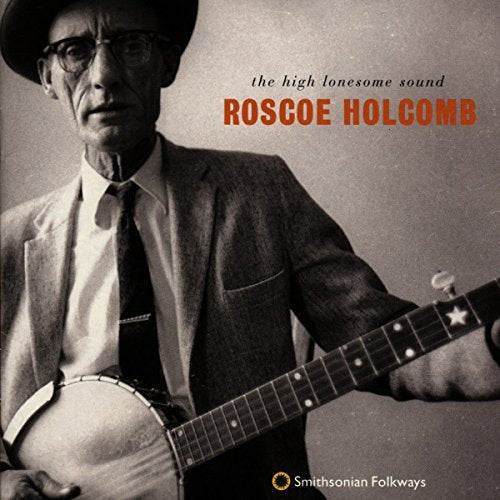 Black and white album cover featuring Roscoe Holcomb holding a banjo, wearing a suit.