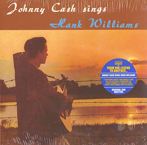 Vinyl album cover with Johnny Cash holding a guitar at sunset.