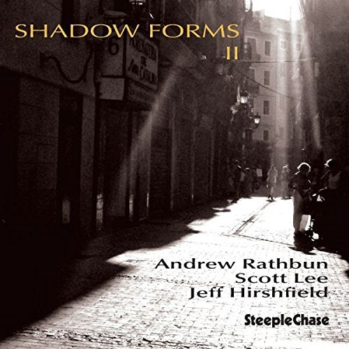 "Album cover: black and white city street scene with 'Shadow Forms II' text."