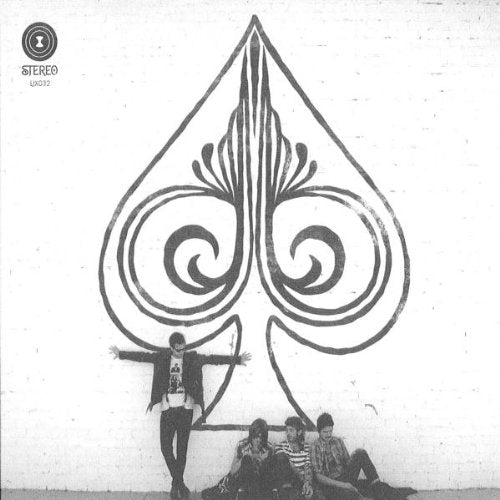 "Black and white album cover with a man and three people sitting below a spade design."