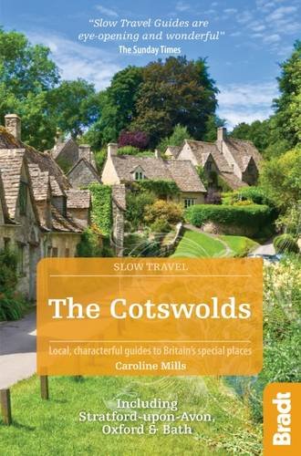 The image shows a travel guide cover with a village scene and orange text overlay.