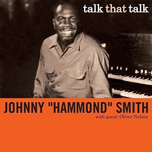 "CD cover with sepia-toned photo of man and piano, orange background, text."