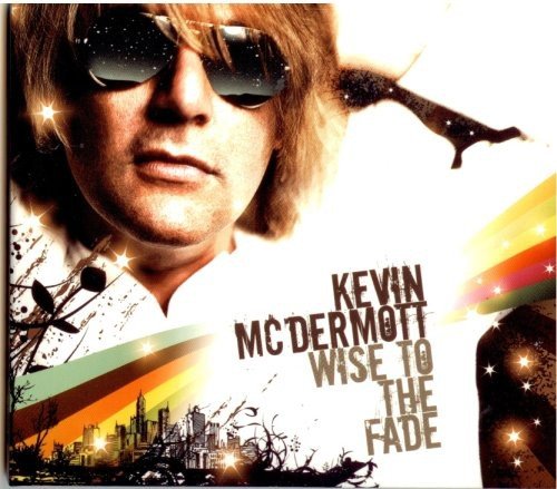 "Album cover with a man wearing sunglasses and cityscape at the bottom."