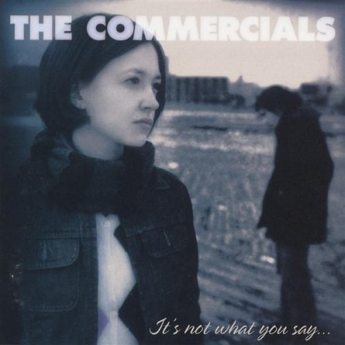 "Album cover featuring a woman and a man in a desolate landscape."