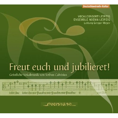 "Green CD cover with musical notes and gold text, featuring a flowing design."