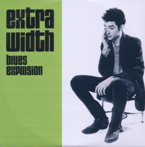 "Album cover with a man sitting on a chair, talking on a phone."