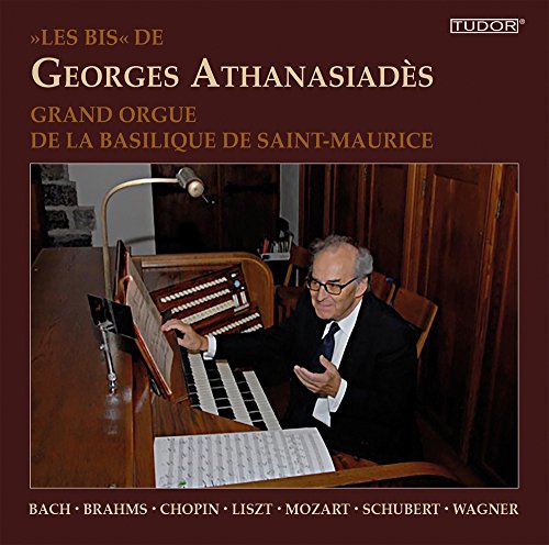 "CD cover featuring a man playing the organ, wearing a suit and tie."