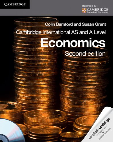 "Economics textbook cover with stacks of gold coins and a CD against a black background."