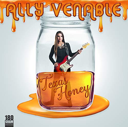 "Album cover featuring a woman in a jar with a guitar."