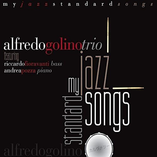 "Album cover with black background, white and red text, and a silver drum graphic."