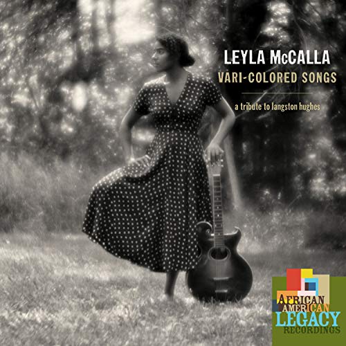 Black and white album cover featuring a woman in a polka dot dress holding a guitar.
