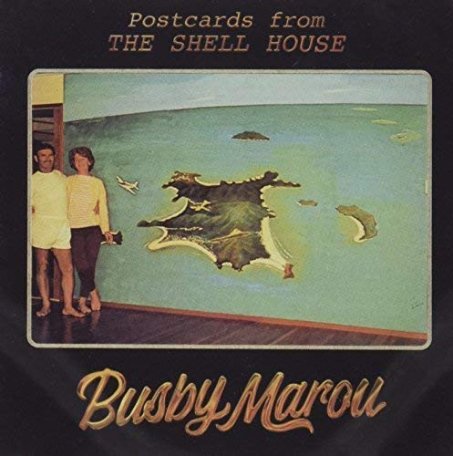 "Album cover with couple on balcony, map of islands, and gold text on black background."