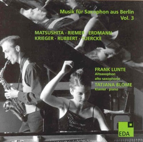Black and white CD cover with saxophonist and pianist, green text and logo.