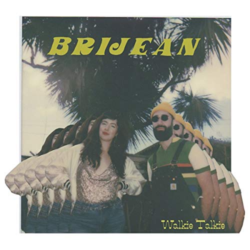 "Album cover with a man and woman standing under a palm tree."