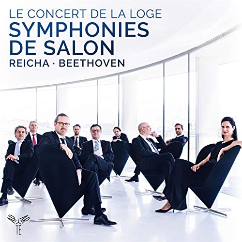 The alt text for the image is: "CD cover featuring musicians seated in modern chairs, dressed formally."