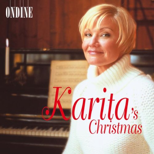 "CD cover featuring a blonde woman in white sweater beside a piano."