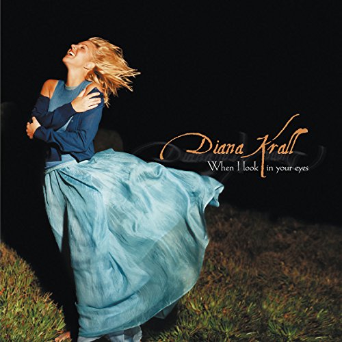 "Diana Krall's album cover featuring a woman in a blue dress outdoors at night."