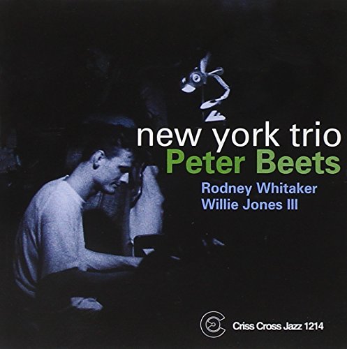 "Album cover featuring a man at a piano, with cartoon rabbit and text."