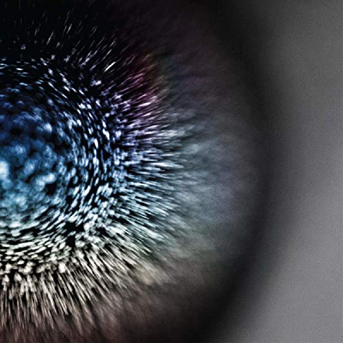 The image shows a close-up of a CD with a textured, abstract design. Alt text: Close-up of a CD with abstract, textured design and radial patterns.