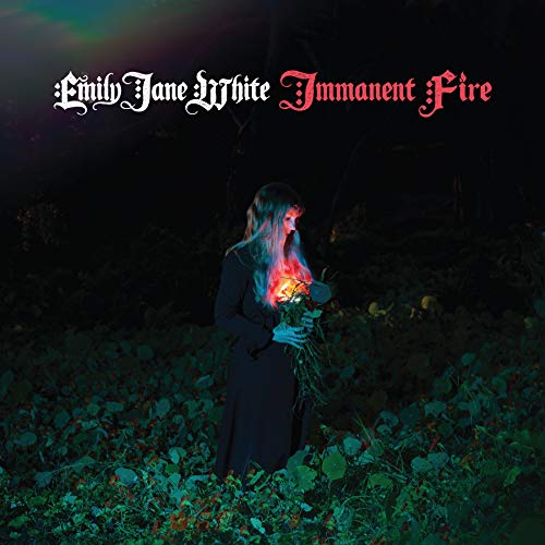 Album cover: woman in dark dress holds burning flowers in a dark forest.