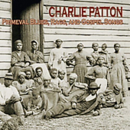 "CD cover featuring a black-and-white image of people gathered outside a wooden building."