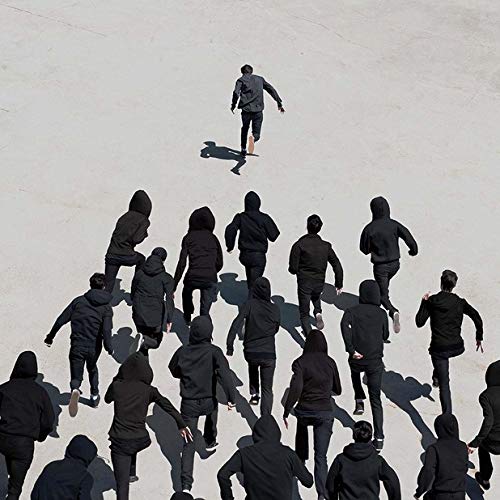 The image depicts a vinyl record cover featuring a person surrounded by others. Alt text: "Vinyl record cover with a person skateboarding away from a group."