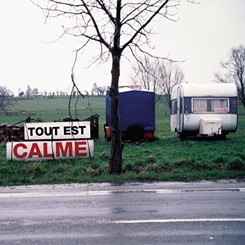 CD cover: roadside scene with a trailer, sign reading "Tout Est Calme".