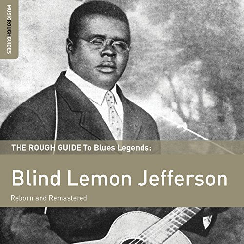 Black and white album cover featuring a man in a suit with a guitar.