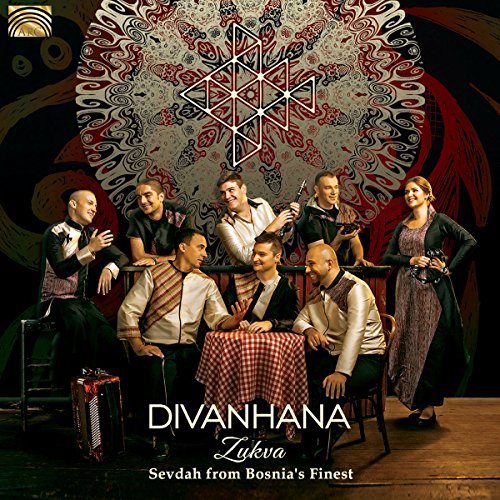 "Album cover featuring a group of people around a table with traditional clothing."