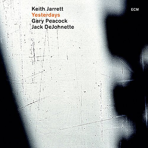 "Album cover with white background, black shadows, and artist names in black and red text."