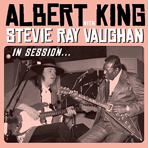 "Music album cover featuring black and white photo of two musicians playing guitars together."
