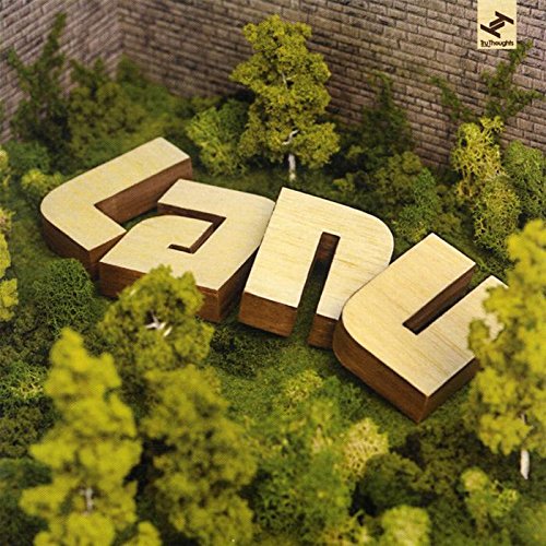 The image shows a CD cover with wooden letters spelling "lanu" in a miniature garden. #### Alt text: "CD cover with wooden 'lanu' in a miniature garden with trees and brick wall."