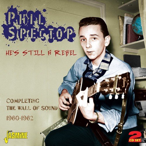 Phil Spector holding a guitar, seated in a room, on a music CD cover.