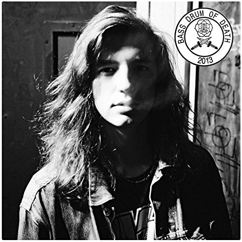 Black and white album cover featuring a man with long hair and a denim jacket.